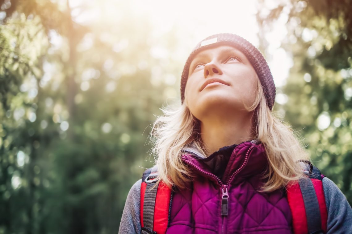 Person With Backpack Walking In The Forest